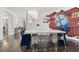 Dining area featuring a concrete table, clear chairs, and colorful wall art at 4 W Wesley Nw Rdg, Atlanta, GA 30327