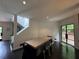 Bright dining area features modern lighting, dark wood floors, and access to the outside through black framed glass doors at 4 W Wesley Nw Rdg, Atlanta, GA 30327