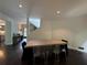 Bright dining area features modern lighting and dark wood floors, leading to other parts of the home and a staircase at 4 W Wesley Nw Rdg, Atlanta, GA 30327