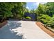 Long driveway leading to a modern black home surrounded by trees at 4 W Wesley Nw Rdg, Atlanta, GA 30327