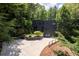 A modern home is surrounded by lush landscaping at 4 W Wesley Nw Rdg, Atlanta, GA 30327