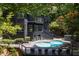 Modern home with a private pool and outdoor lounge area surrounded by lush greenery at 4 W Wesley Nw Rdg, Atlanta, GA 30327