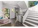 Elegant foyer with staircase, modern lighting, wood floors, and mirrored walls at 4 W Wesley Nw Rdg, Atlanta, GA 30327