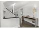 Bright foyer with dark floors, modern console, and stairway at 4 W Wesley Nw Rdg, Atlanta, GA 30327