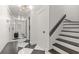 Stylish hallway features sleek black and white floors with access to stairway at 4 W Wesley Nw Rdg, Atlanta, GA 30327