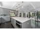 Bright kitchen with stainless steel appliances, large island, and folding doors to the outdoor patio at 4 W Wesley Nw Rdg, Atlanta, GA 30327