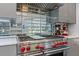 Close-up of the kitchen range and stainless steel appliances against the mirrored tile backsplash at 4 W Wesley Nw Rdg, Atlanta, GA 30327
