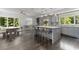 Open concept kitchen with grey cabinets, stainless steel appliances, large island, and attached dining area at 4 W Wesley Nw Rdg, Atlanta, GA 30327