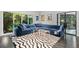 Modern living room with large blue sectional sofa, zebra rug, and views of the backyard at 4 W Wesley Nw Rdg, Atlanta, GA 30327