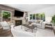 Cozy living room featuring a fireplace, wood accent wall, and ample natural light at 4 W Wesley Nw Rdg, Atlanta, GA 30327