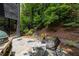 Charming stone patio with seating area and lush green surroundings at 4 W Wesley Nw Rdg, Atlanta, GA 30327