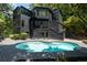 Stunning backyard with sparkling pool and contemporary home nestled in trees at 4 W Wesley Nw Rdg, Atlanta, GA 30327