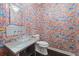 Unique powder room with bright wall art and a glass bowl sink at 4 W Wesley Nw Rdg, Atlanta, GA 30327