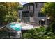 Modern home boasts an outdoor pool, patio, and architectural details, nestled within a lush landscape at 4 W Wesley Nw Rdg, Atlanta, GA 30327