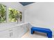 Bright sitting area with white cabinets, large window, and blue bench at 4 W Wesley Nw Rdg, Atlanta, GA 30327