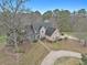 Aerial view of a home with mature trees and a circular driveway, showcasing its serene and private setting at 905 Attaway Rd, Bowdon, GA 30108