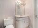 Bathroom with vanity, mirror, and striped wall coverings at 905 Attaway Rd, Bowdon, GA 30108