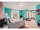 Bright teal bedroom with carpet, large windows and white trim at 905 Attaway Rd, Bowdon, GA 30108