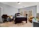 Comfortable bedroom with hardwood floors and natural light from three windows at 905 Attaway Rd, Bowdon, GA 30108