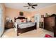 Cozy primary bedroom with a ceiling fan, carpet, and an ensuite bath at 905 Attaway Rd, Bowdon, GA 30108