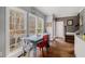 Bright dining area features large windows and hardwood floors, creating a warm and inviting atmosphere at 905 Attaway Rd, Bowdon, GA 30108