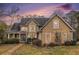 Charming home with cedar shake siding, well-manicured lawn, and lush landscaping at 905 Attaway Rd, Bowdon, GA 30108