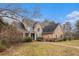 Inviting two-story home with a covered porch, complemented by mature landscaping and a brick walkway at 905 Attaway Rd, Bowdon, GA 30108