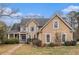 Charming two-story home with wood siding, complemented by lush landscaping and a welcoming blue front door at 905 Attaway Rd, Bowdon, GA 30108