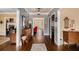 Inviting hallway with hardwood floors and elegant trim, leading to various rooms at 905 Attaway Rd, Bowdon, GA 30108