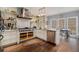 Open kitchen with stainless steel appliances, center island, white cabinets, and hardwood flooring at 905 Attaway Rd, Bowdon, GA 30108