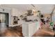 Open concept kitchen with stainless appliances, center island, and view into adjacent living room with fireplace at 905 Attaway Rd, Bowdon, GA 30108