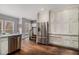 Spacious kitchen featuring stainless steel refrigerator, extensive cabinetry, and hardwood floors at 905 Attaway Rd, Bowdon, GA 30108