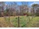 Property with a fenced yard and small shed, offering outdoor storage and potential for a garden at 905 Attaway Rd, Bowdon, GA 30108