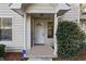 Inviting front entrance with covered porch, decorative door, and manicured landscaping at 164 Adrian Dr, Stockbridge, GA 30281