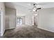 Spacious living room with sliding glass door and neutral colored carpet at 164 Adrian Dr, Stockbridge, GA 30281