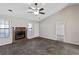 Cozy living room with stone fireplace, vaulted ceiling, and neutral carpet at 164 Adrian Dr, Stockbridge, GA 30281