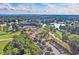 Extensive community amenities, including tennis courts and a lake surrounded by mature trees in an aerial view at 2480 Roxburgh Dr, Roswell, GA 30076
