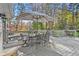 Inviting outdoor deck featuring a dining area with seating for six and scenic views of the lush backyard at 2480 Roxburgh Dr, Roswell, GA 30076
