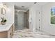 Bright bathroom featuring a glass-enclosed shower, marble floors, and a modern vanity at 2480 Roxburgh Dr, Roswell, GA 30076