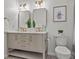 Bright bathroom featuring a double vanity, modern fixtures, framed mirrors, and contemporary decorations at 2480 Roxburgh Dr, Roswell, GA 30076