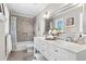Well-lit bathroom with dual-sink vanity, shower with tile surround, and large decorative mirror at 2480 Roxburgh Dr, Roswell, GA 30076