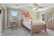 Cozy bedroom featuring bright windows, carpeted floor, ceiling fan, and decorative floral accents at 2480 Roxburgh Dr, Roswell, GA 30076