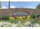 Stone entrance sign for the Country Club of Roswell, Willow Springs, with flowering bushes and greenery at 2480 Roxburgh Dr, Roswell, GA 30076