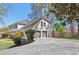 Side exterior view of the home with an attached two car garage and long driveway at 2480 Roxburgh Dr, Roswell, GA 30076