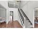 Grand foyer with high ceilings, hardwood floors, and staircase with iron railing at 2480 Roxburgh Dr, Roswell, GA 30076