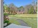 View of the expansive, lush front yard and walkway leading to the charming home at 2480 Roxburgh Dr, Roswell, GA 30076