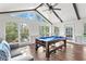 Bright, vaulted game room with a pool table, white walls, and a fan with wooden beams at 2480 Roxburgh Dr, Roswell, GA 30076
