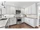 Bright kitchen with white cabinetry, granite countertops, and stainless steel appliances at 2480 Roxburgh Dr, Roswell, GA 30076