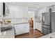 Well-equipped kitchen with stainless steel refrigerator, granite countertops, and subway tile backsplash at 2480 Roxburgh Dr, Roswell, GA 30076