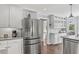 Bright kitchen features white cabinets, subway tile backsplash, granite countertops, and stainless steel appliances at 2480 Roxburgh Dr, Roswell, GA 30076